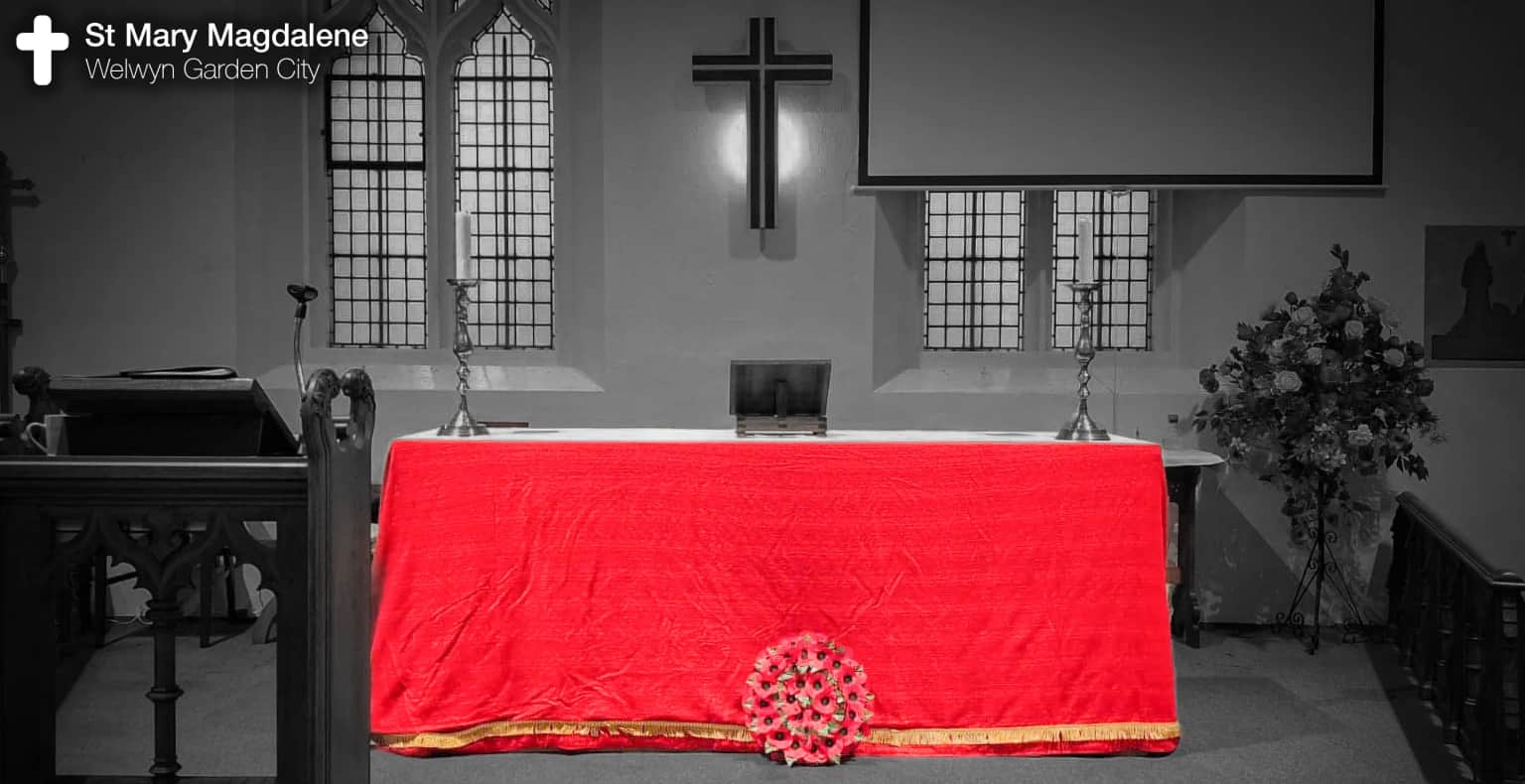 The alter in the Church covered in red with a wreath